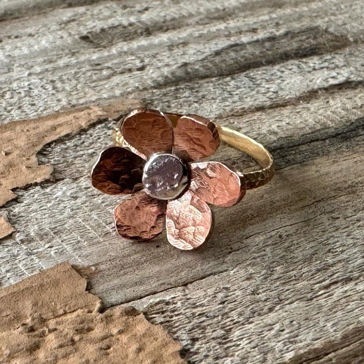 Handmade mixed metal floret ring in copper, silver, and brass with rustic floral design, artisan-crafted in California