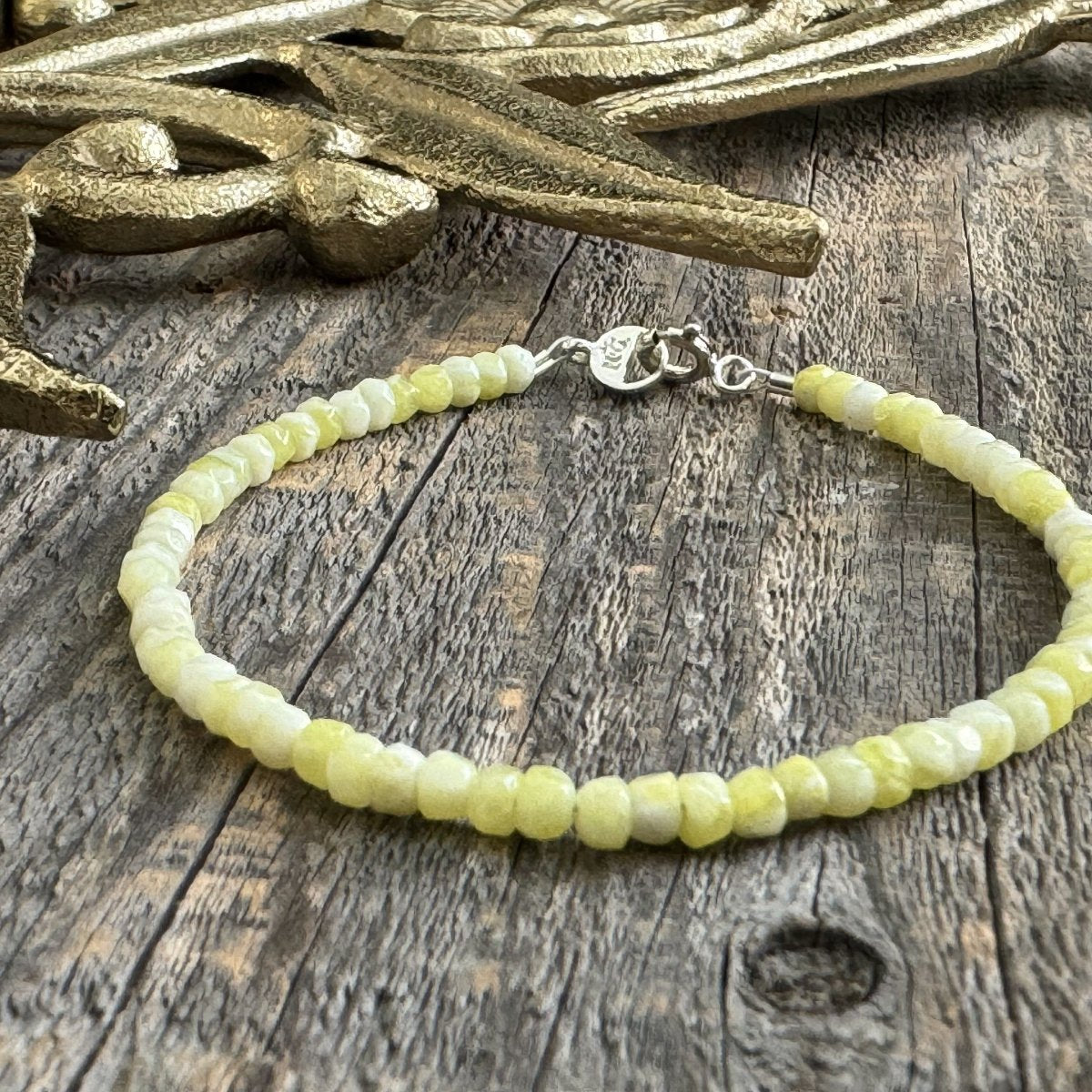Lemon Jade gemstone bracelet with sterling silver clasp resting on weathered wood – handcrafted Oatman Bracelet inspired by historic Route 66 town, by Narrow-Gauge Designs