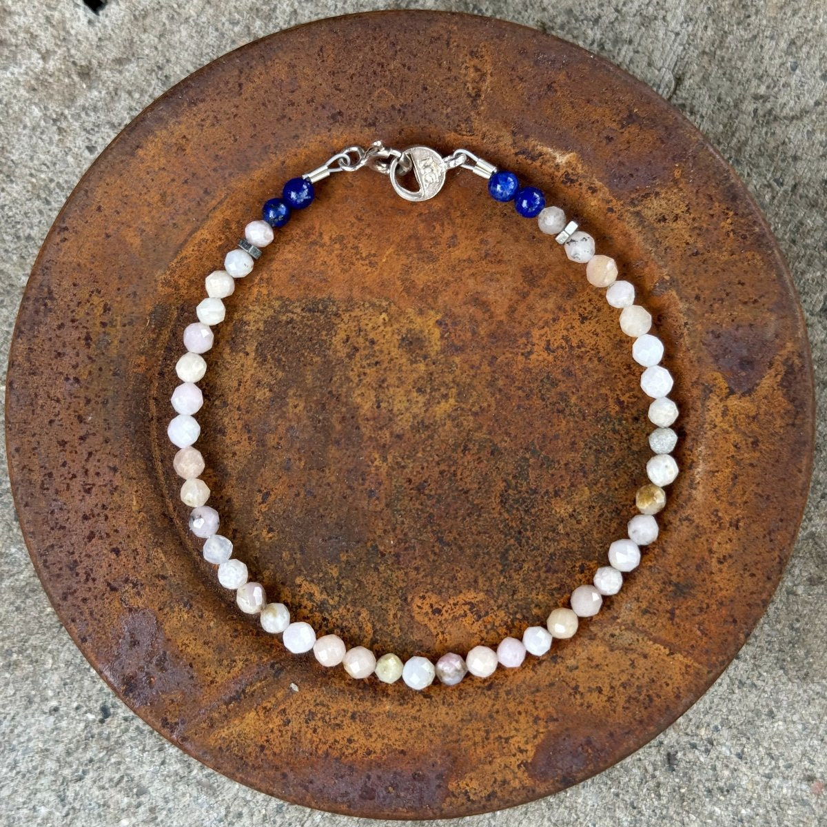 Full view of Opal and Lapis gemstone bracelet on a rusted metal lid – handcrafted Ouray Bracelet by Narrow-Gauge Designs