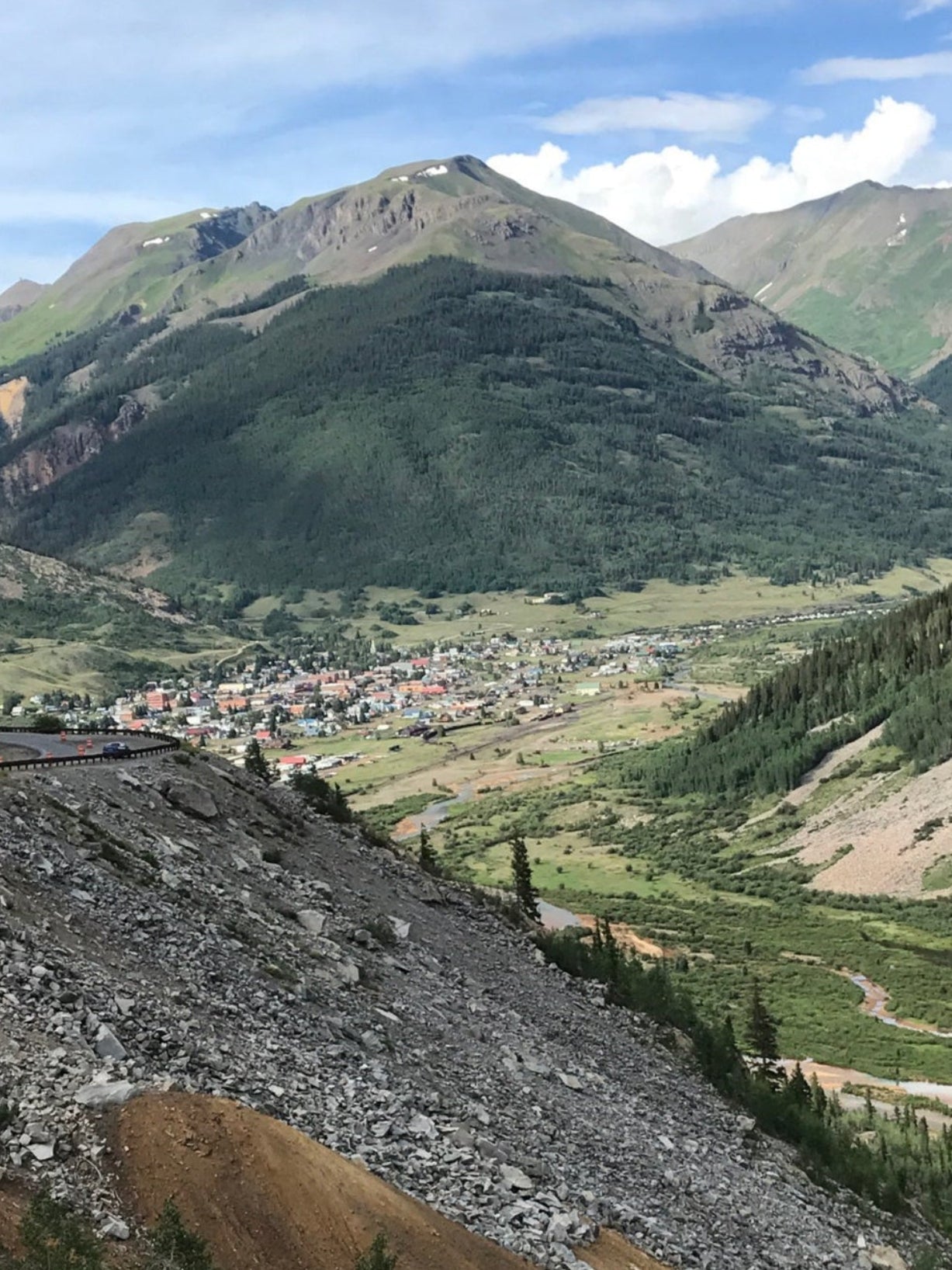 Scenic view of Silverton, Colorado, taken from the roadside with historic buildings and mountainous landscape in the background.